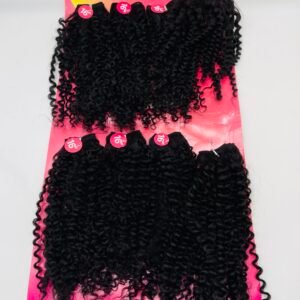 Curly black hair extensions on a bright pink display card reading CLARA, with 16-inch length stickers visible.