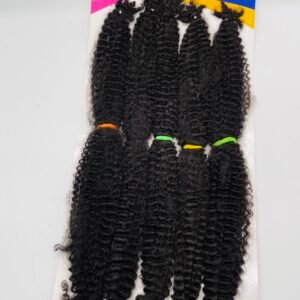 Package of long, curly black hair extensions displayed on a pink and yellow product card labeled Keston Hair