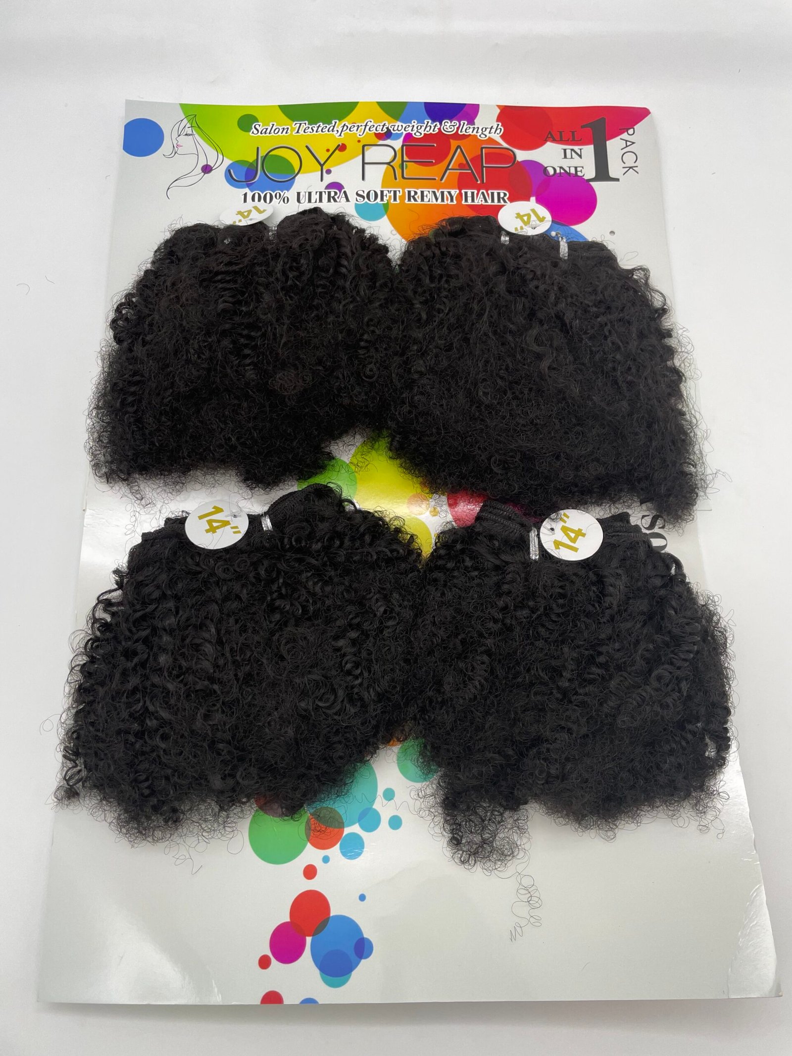 Black, tight-curly hair extensions arranged on a colorful product display card with brand name Joy Reap visible at the top (hair accessory packaging).