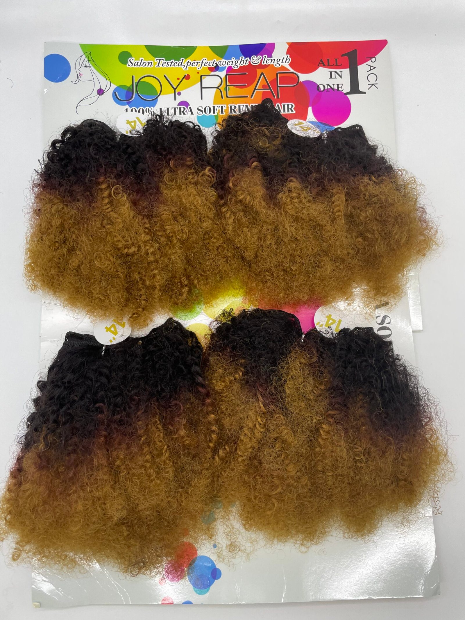 Curly hair extensions in an ombre black-to-blonde gradient displayed on colorful packaging background with text Joy Reap styling product