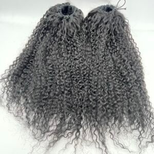Back view of two high, tightly curled black hair sections tied with small elastics at the crown.