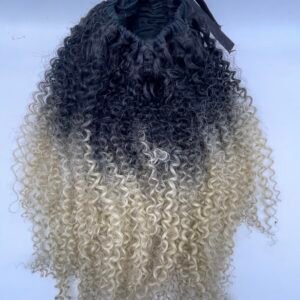 Back view of a person with tight dark-to-blonde ombre curls and a black hair band at the crown