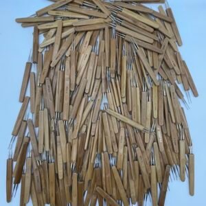 Pile of wooden-handled tools with thin metal probes, scattered on a light blue surface; handles are labeled with measurements like 0.5 mm.