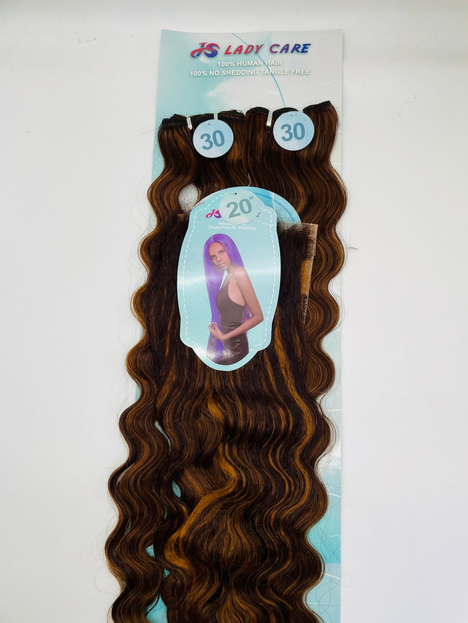 Long, wavy brown hair extensions on display with blue circular tags reading '30' and a poster behind them.