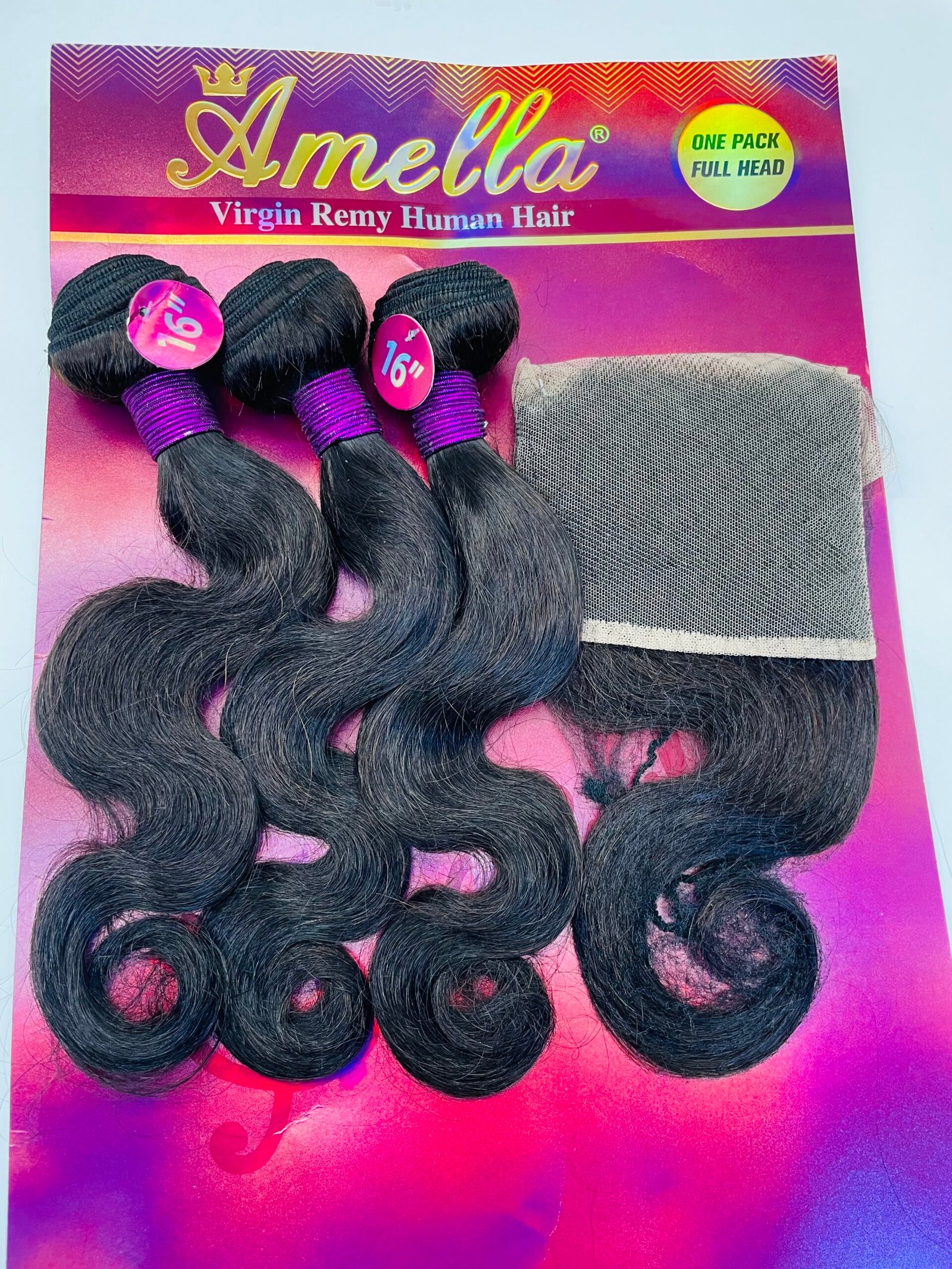Three black hair extension bundles tied with purple wraps, displayed on Amella Virgin Remy Human Hair packaging with a hair net nearby.