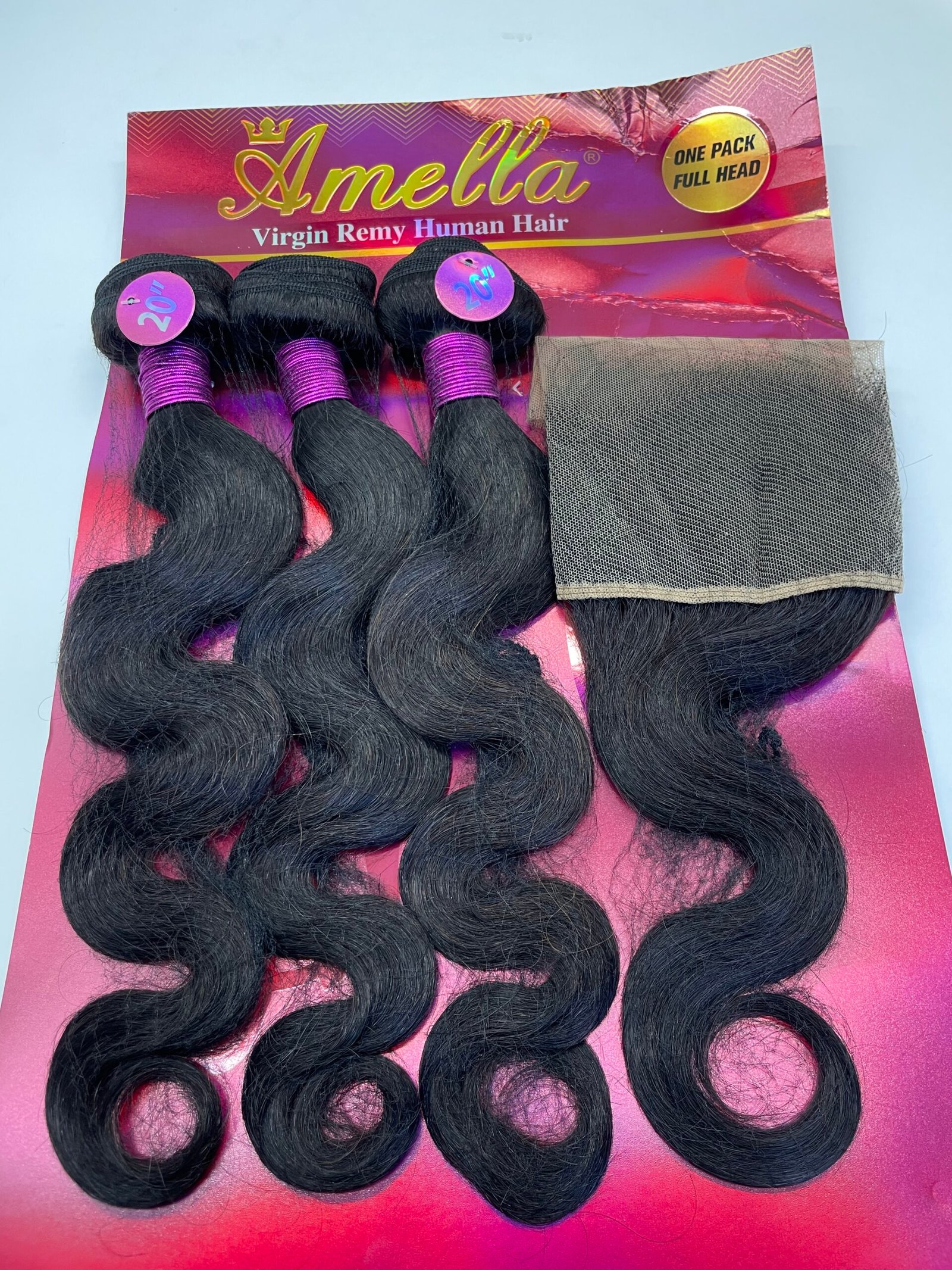 Bundles of long black hair extensions with pink and purple packaging labeled 'Amella Virgin Remy Human Hair' (20 inch)