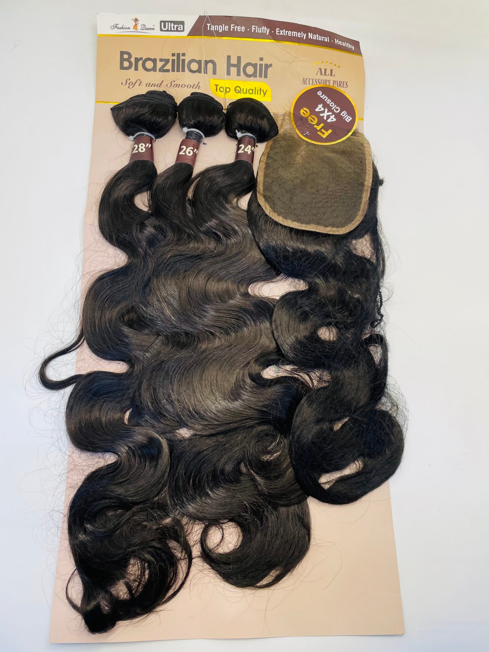 Hair extension wefts with lengths 28", 26", and 24" attached to a beige display card labeled 'Brazilian Hair' and a beige wig cap on the side.