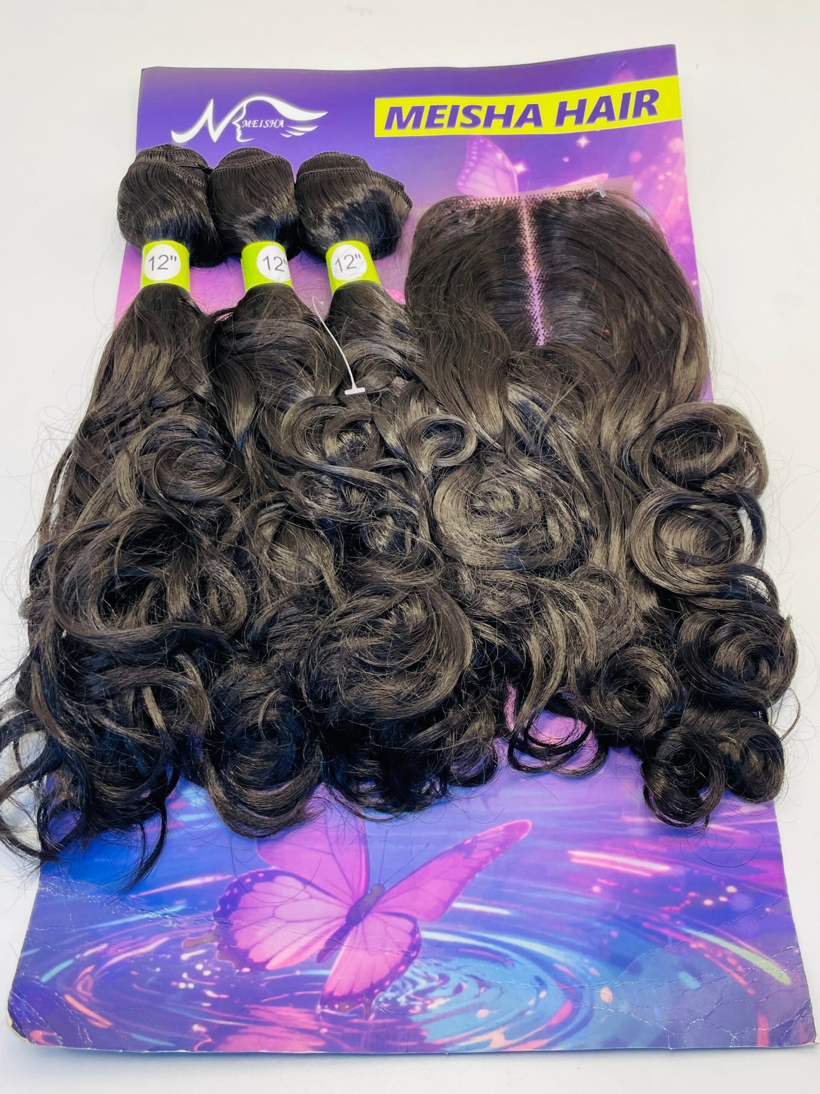 Three dark brown, curly hair extensions labeled 12 inches, laid on a purple butterfly-themed display.
