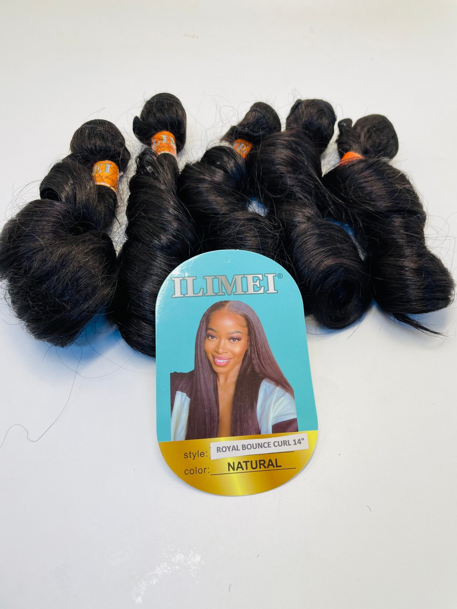 Group of black hair extension bundles with orange bands on a blue display card that says ILIMEI and features a model image.
