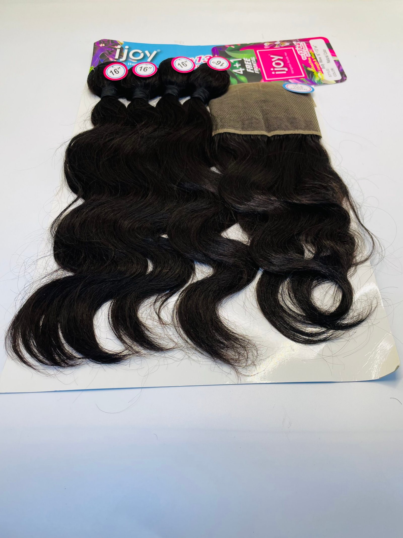 Dark brown, wavy hair extensions in bundles attached to a colorful package with 16" length labels.