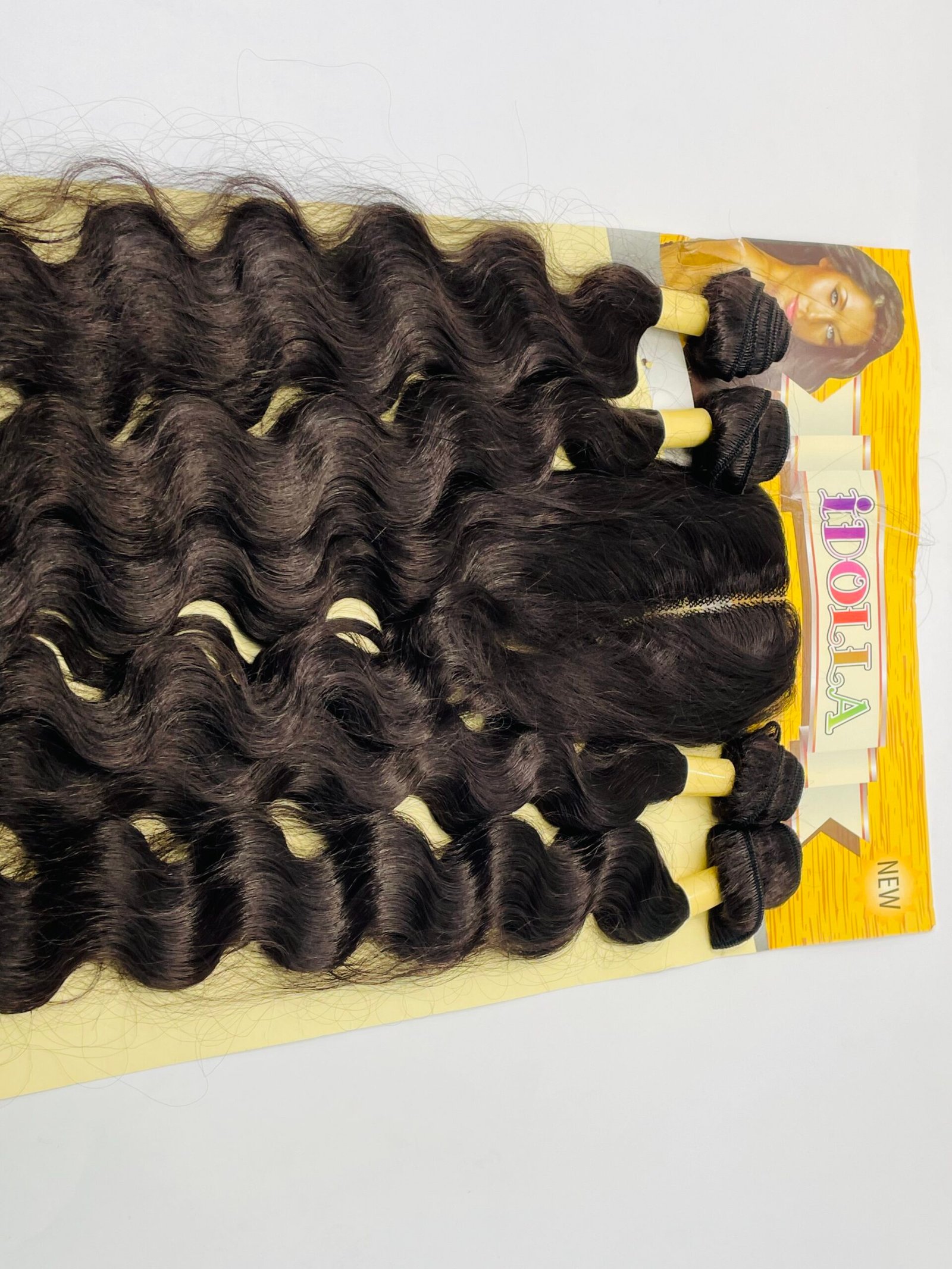 Rows of dark, wavy hair extensions attached to a yellow display card with a model photo in the corner.