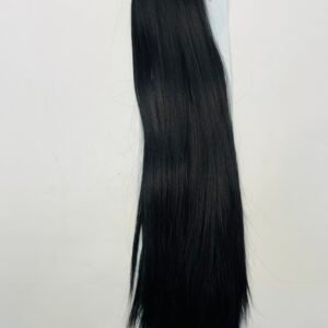 Long, straight black hair extension hanging against a white background with red packaging at the top of the image.