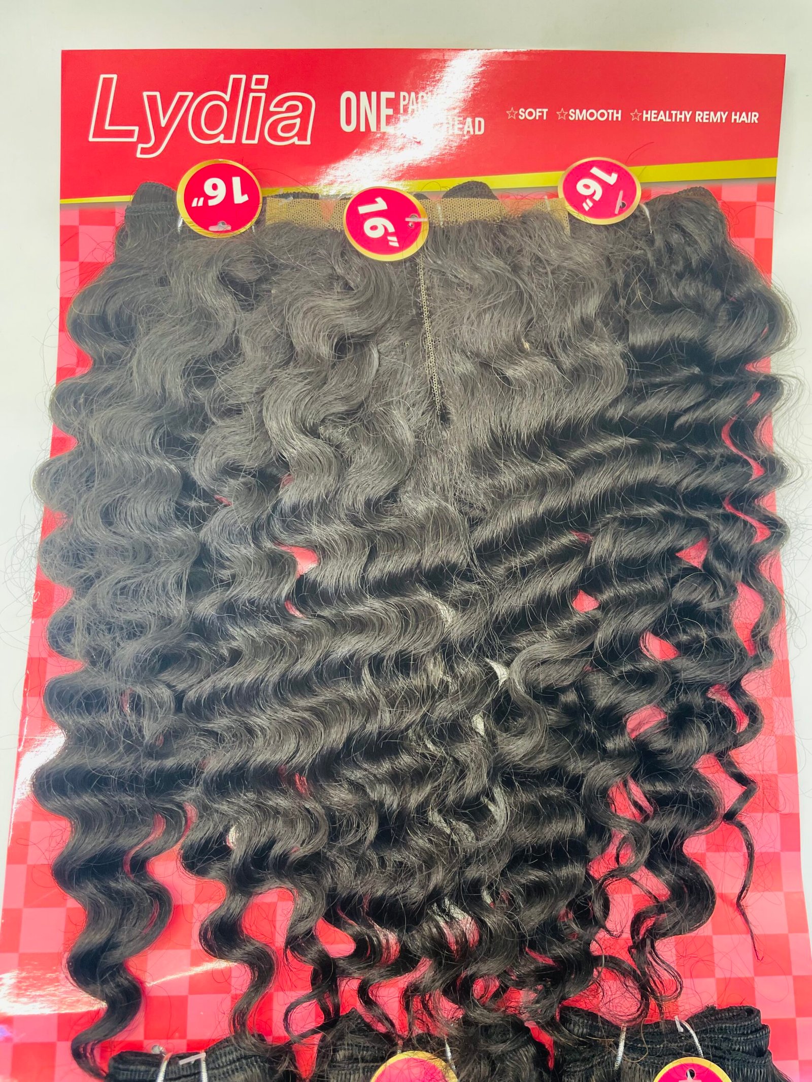 Dark curly hair extensions displayed on a red Lydia product card with 16-inch circles