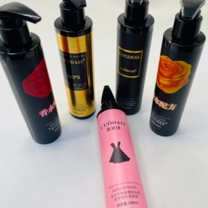 Group of black pump bottles for hair styling, some with rose images and gold labels, standing upright on a white surface.