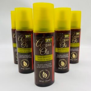 Row of brown Argan Oil hair spray bottles with yellow ribbed caps on a white background, lined up neatly.