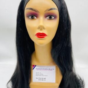 Adult mannequin head with long black wig and bold makeup, headband across forehead, label on chest area for display purposes
