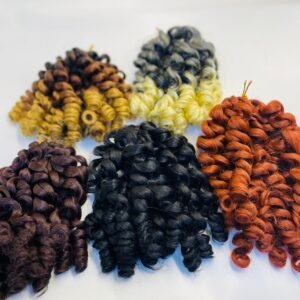 Close-up of thick braided yarn samples in black, brown, yellow, orange, and gray laid on a white surface.