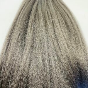 Back view of a person with long gray hair, standing against a light wall in a bright setting