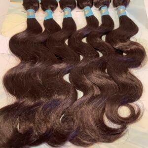 Five dark brown hair wefts with blue bands labeled 'ON' laid in a row on a light blue poster board backdrop, showing wavy texture and glossy finish.