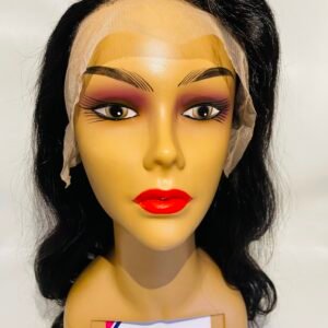 Mannequin head with long black wig wearing a beige wig cap; label reads 'WANGECHI HAIR & BEAUTY' attached to the neck.