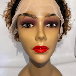 Mannequin head wearing a beige wig cap with a sheer net, bold eyebrows, purple eye makeup, and bright red lips.